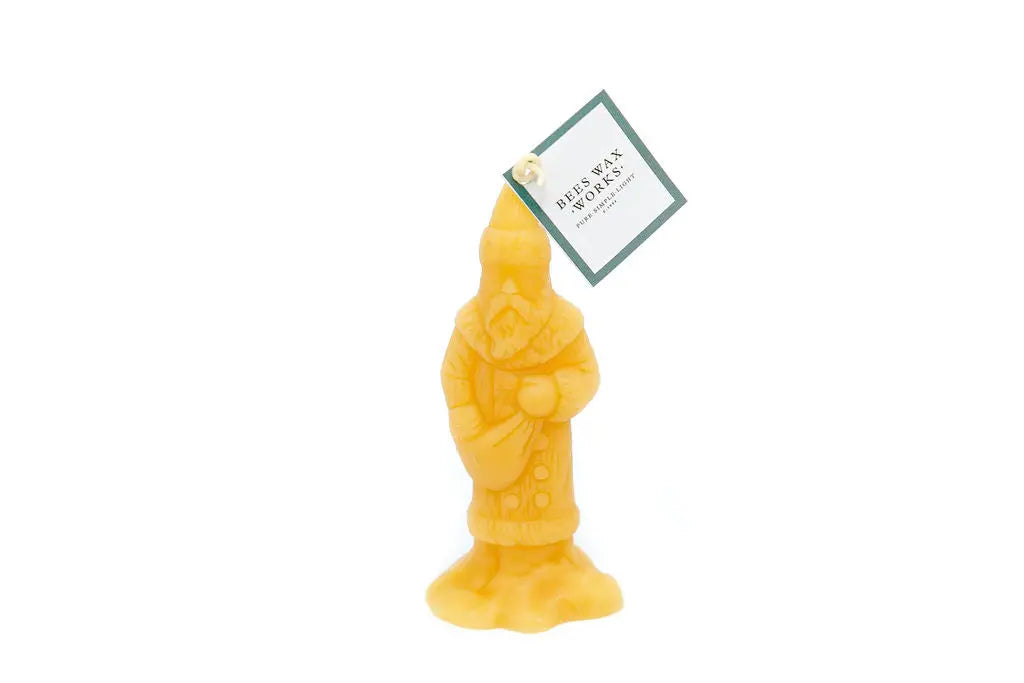 Victorian Santa candle with a paper hang tag on the wick, shown on a white background.
